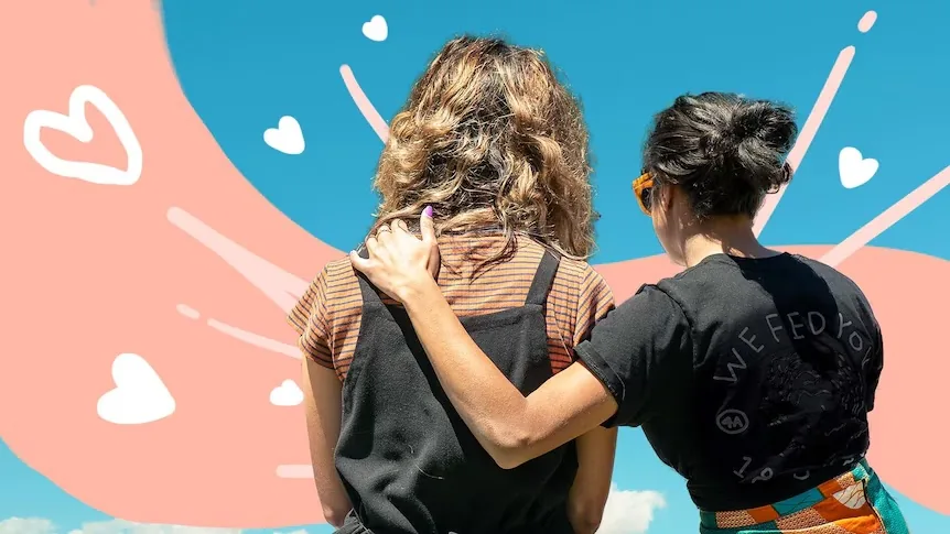 One person offers another a supportive arm around the shoulders